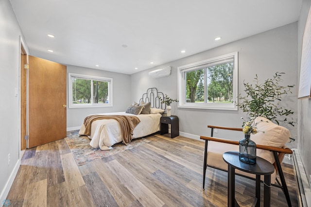 2702 2nd St N, Fargo, ND 58102 - bedroom featuring an AC wall unit, wood finished floors, and recessed lighting