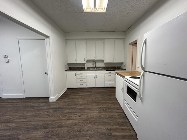501 River St, Colfax, WI 54730 - kitchen featuring white appliances, a sink, white cabinetry, dark wood-style flooring, and dark countertops