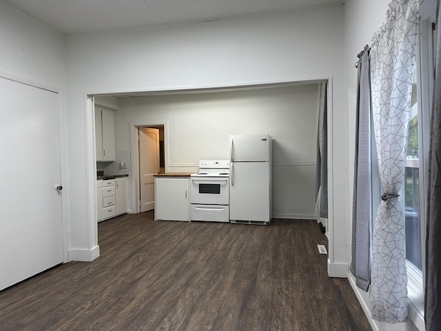 501 River St, Colfax, WI 54730 - kitchen with white appliances, dark wood-type flooring, white cabinets, and baseboards