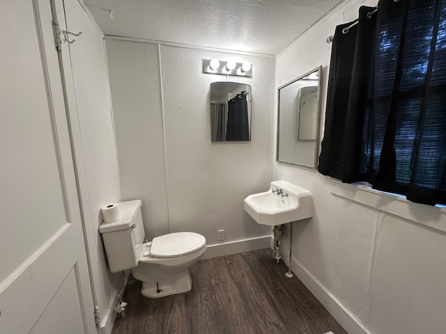 501 River St, Colfax, WI 54730 - bathroom with wood finished floors, toilet, and a textured ceiling
