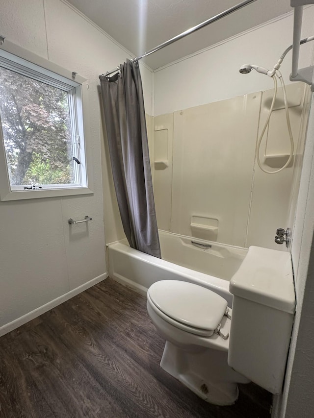 501 River St, Colfax, WI 54730 - full bath with toilet, shower / tub combo with curtain, wood finished floors, and baseboards