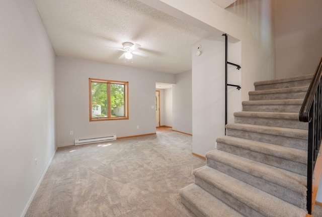11 1st St, Nashwauk, MN 55769 - staircase with a baseboard heating unit, ceiling fan, carpet floors, and a textured ceiling