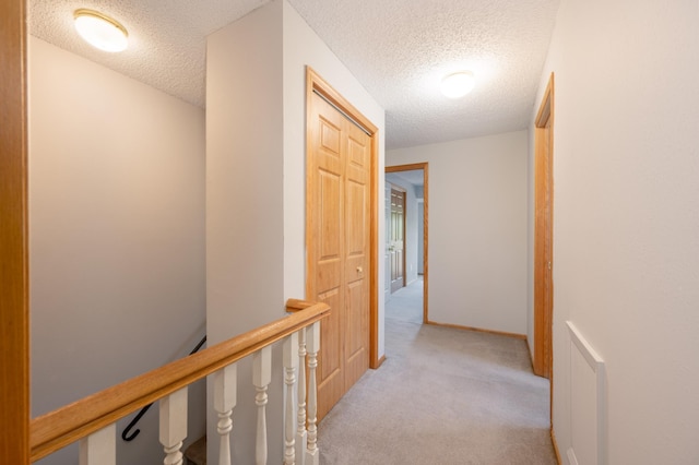 11 1st St, Nashwauk, MN 55769 - hallway with a textured ceiling, light carpet, and an upstairs landing