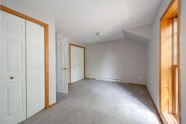 11 1st St, Nashwauk, MN 55769 - unfurnished bedroom featuring a baseboard heating unit and light colored carpet