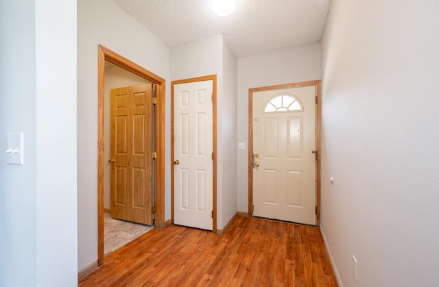 11 1st St, Nashwauk, MN 55769 - entryway featuring light wood finished floors and a textured ceiling