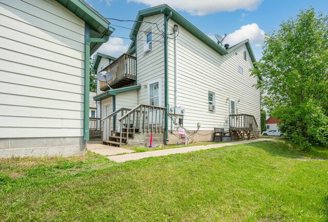 11 1st St, Nashwauk, MN 55769 - back of house featuring a balcony and a yard
