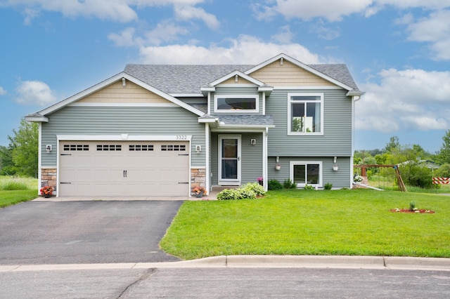 3322 Orchard Ave NE, Sauk Rapids, MN 56379 - view of front of home with asphalt driveway, a front yard, roof with shingles, an attached garage, and stone siding