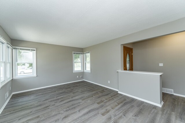 912 11 1/2 St SW, Rochester, MN 55902 - unfurnished room with wood finished floors and a textured ceiling