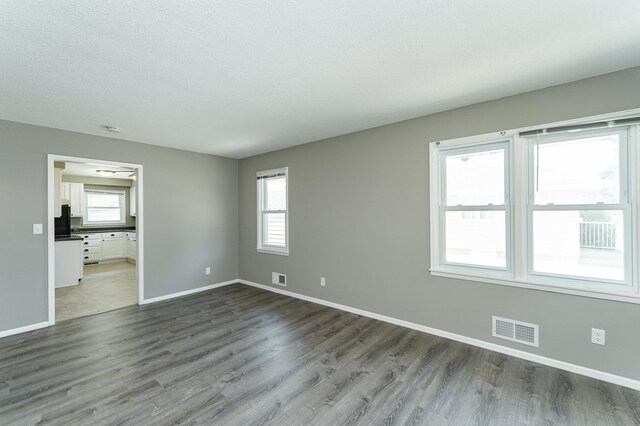 912 11 1/2 St SW, Rochester, MN 55902 - unfurnished room featuring dark wood finished floors and a smoke detector