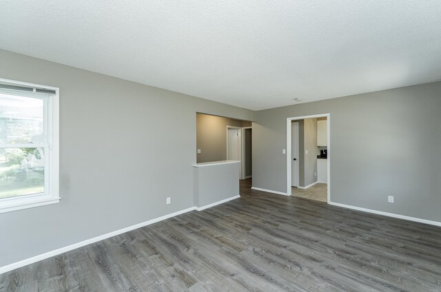 912 11 1/2 St SW, Rochester, MN 55902 - empty room with wood finished floors and a textured ceiling