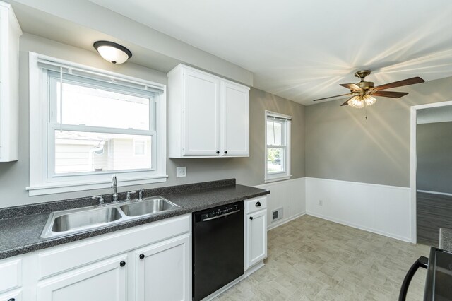 912 11 1/2 St SW, Rochester, MN 55902 - kitchen featuring black dishwasher, dark countertops, white cabinetry, ceiling fan, and light floors