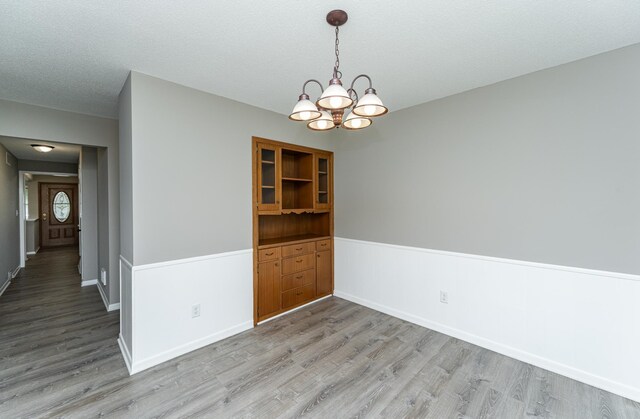 912 11 1/2 St SW, Rochester, MN 55902 - unfurnished dining area with a chandelier and light wood finished floors