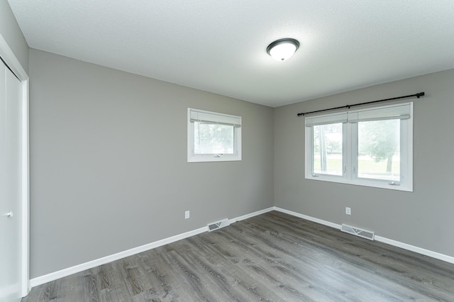 912 11 1/2 St SW, Rochester, MN 55902 - unfurnished bedroom featuring wood finished floors and a closet