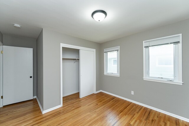 912 11 1/2 St SW, Rochester, MN 55902 - unfurnished bedroom with light wood-type flooring and a closet
