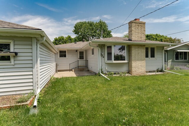 912 11 1/2 St SW, Rochester, MN 55902 - rear view of property with a chimney and a shingled roof