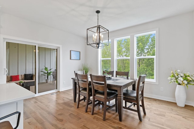 14960 143rd Ave N, Dayton, MN 55327 - dining space featuring a chandelier, light wood-style flooring, and baseboards