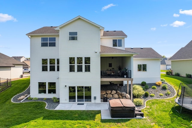 14960 143rd Ave N, Dayton, MN 55327 - rear view of property featuring a trampoline, a patio area, and a yard
