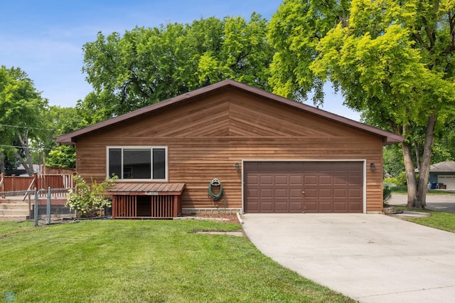 1301 5th Ave N, Moorhead, MN 56560 - chalet / cabin featuring a garage, driveway, a front lawn, and a wooden deck