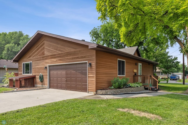 1301 5th Ave N, Moorhead, MN 56560 - view of side of property featuring a lawn, driveway, and a garage