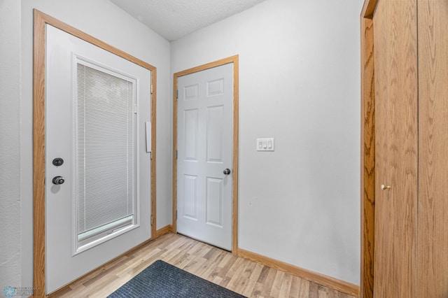 1301 5th Ave N, Moorhead, MN 56560 - doorway with light wood-type flooring and baseboards