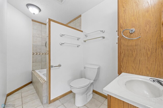 1301 5th Ave N, Moorhead, MN 56560 - bathroom with tile patterned floors, vanity, and a textured ceiling
