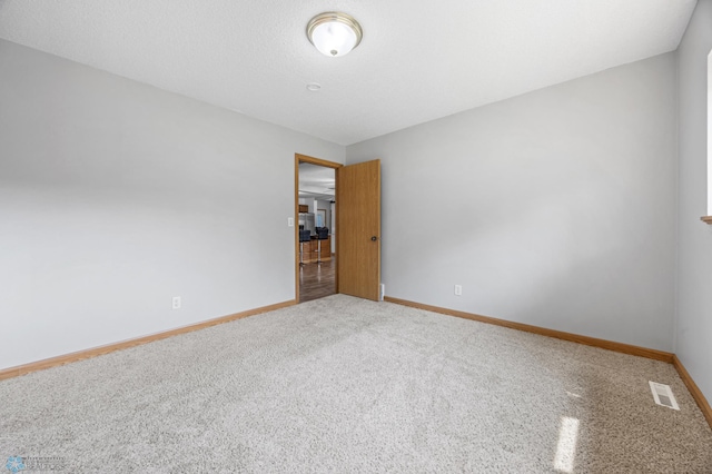 1301 5th Ave N, Moorhead, MN 56560 - carpeted spare room featuring baseboards