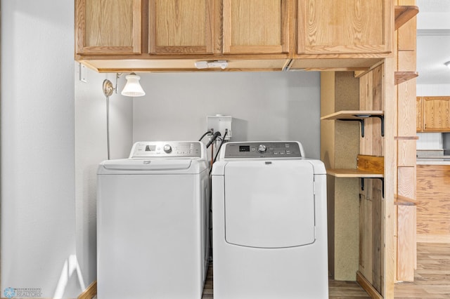 1301 5th Ave N, Moorhead, MN 56560 - laundry room featuring washer and dryer, cabinet space, and wood finished floors
