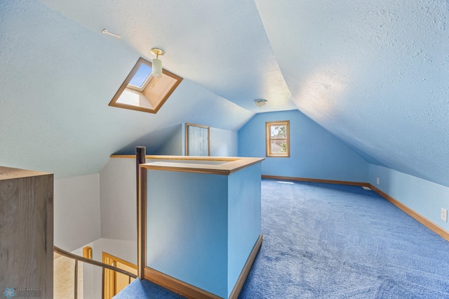 1301 5th Ave N, Moorhead, MN 56560 - bonus room featuring a textured ceiling, a skylight, vaulted ceiling, and carpet floors