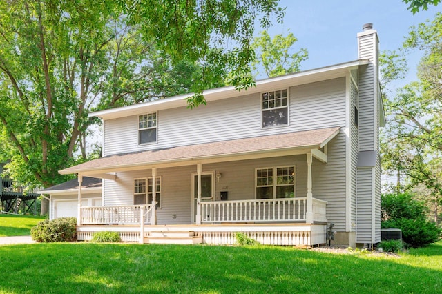 741 3rd St NE, Faribault, MN 55021 - view of front of property with a chimney, covered porch, a front yard, and a garage