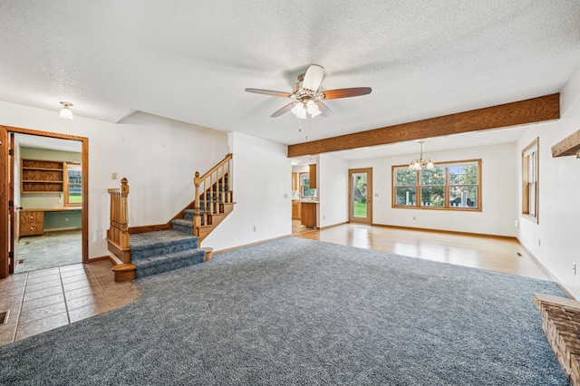 741 3rd St NE, Faribault, MN 55021 - unfurnished living room featuring carpet flooring, a textured ceiling, a ceiling fan, stairway, and tile patterned flooring