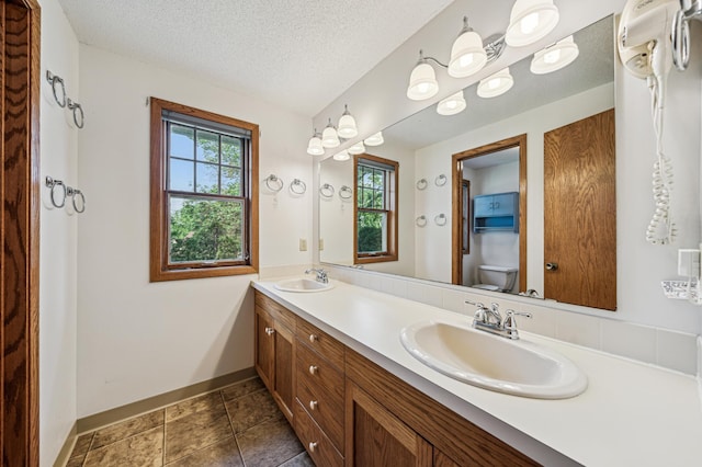 741 3rd St NE, Faribault, MN 55021 - full bathroom with double vanity and a textured ceiling