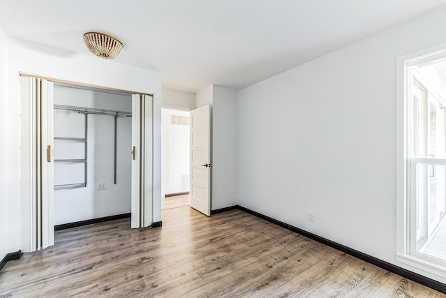 6417 Colony Way Unit 2A, Edina, MN 55435 - unfurnished bedroom featuring light wood-style flooring, a closet, and baseboards