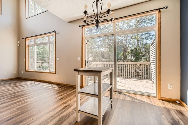 604 Crane Creek Ln, Eagan, MN 55121 - unfurnished dining area featuring wood finished floors and a chandelier