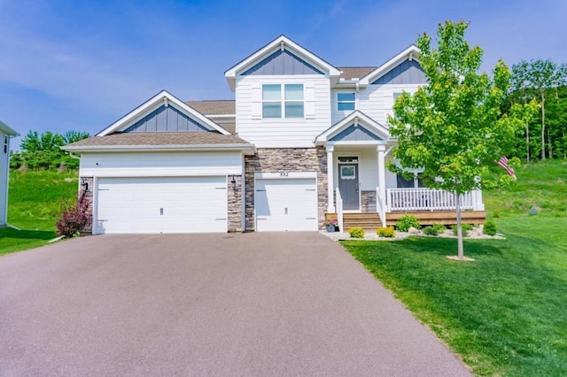 882 Redmond Dr, Carver, MN 55315 - craftsman house with board and batten siding, driveway, a front yard, stone siding, and a porch