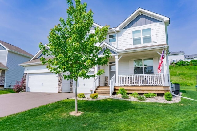 882 Redmond Dr, Carver, MN 55315 - view of front of home with covered porch, concrete driveway, board and batten siding, a front lawn, and an attached garage