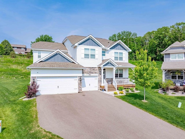 882 Redmond Dr, Carver, MN 55315 - view of front of property with asphalt driveway, a porch, stone siding, and a front lawn