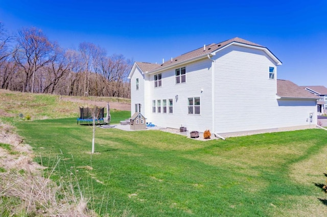 882 Redmond Dr, Carver, MN 55315 - back of house featuring a trampoline and a lawn