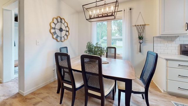 401 5th St NE, Barnesville, MN 56514 - dining room with a chandelier, baseboards, and light wood-style floors