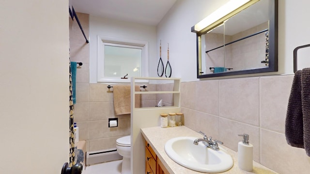 401 5th St NE, Barnesville, MN 56514 - full bathroom featuring a baseboard heating unit, tile walls, toilet, and vanity