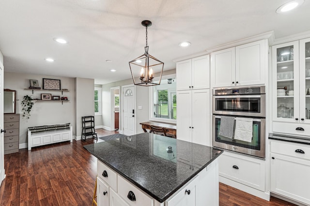 18160 Echo Ave, Faribault, MN 55021 - kitchen with stainless steel double oven, a kitchen island, recessed lighting, white cabinets, and dark wood-style flooring