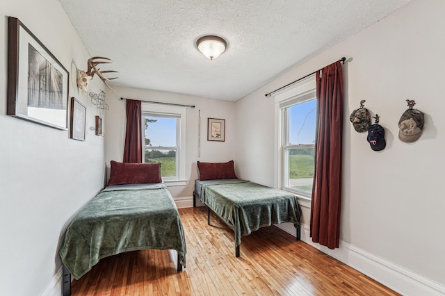 18160 Echo Ave, Faribault, MN 55021 - bedroom with a textured ceiling and light wood-style floors