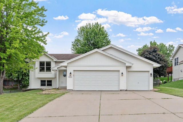 14441 Alabama Ave S, Savage, MN 55378 - view of front of property featuring an attached garage, concrete driveway, a front lawn, and board and batten siding