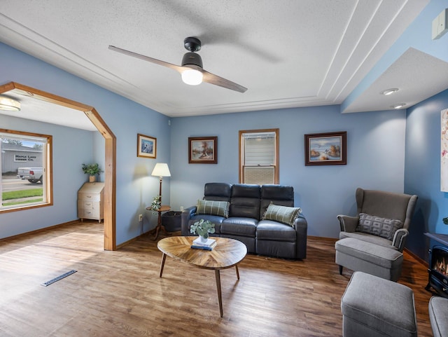 45 Oak Ave S, Maple Lake, MN 55358 - living room with wood finished floors, ceiling fan, arched walkways, and a textured ceiling