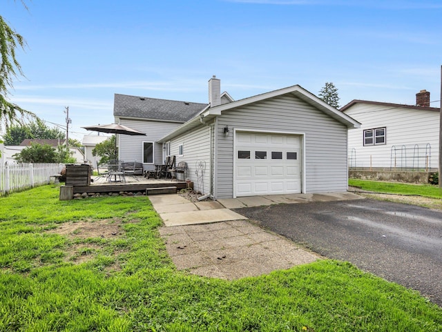 45 Oak Ave S, Maple Lake, MN 55358 - view of front of home with a deck, asphalt driveway, a chimney, a shingled roof, and a garage