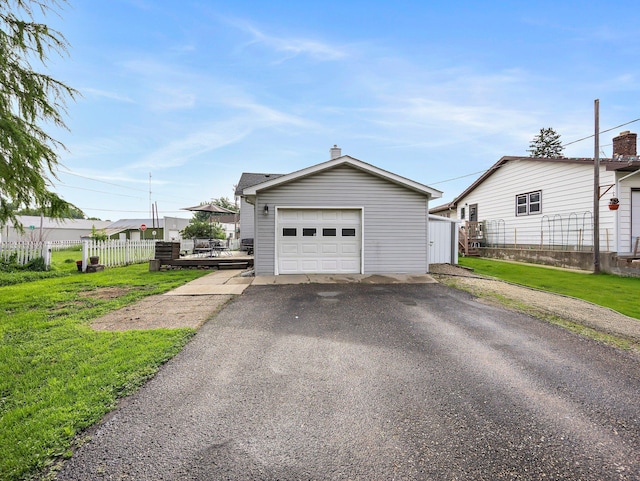 45 Oak Ave S, Maple Lake, MN 55358 - view of front facade featuring a garage, asphalt driveway, an outdoor structure, and a chimney