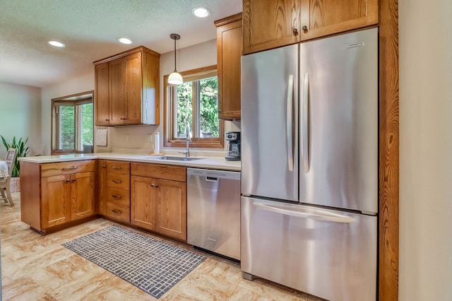 1204 20th Ave S, Moorhead, MN 56560 - kitchen featuring appliances with stainless steel finishes, plenty of natural light, a peninsula, recessed lighting, and light countertops