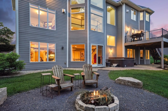 3287 Norcrest Ave N, Baytown Twp, MN 55082 - back of house featuring a hot tub, an outdoor fire pit, a patio area, a wooden deck, and a yard