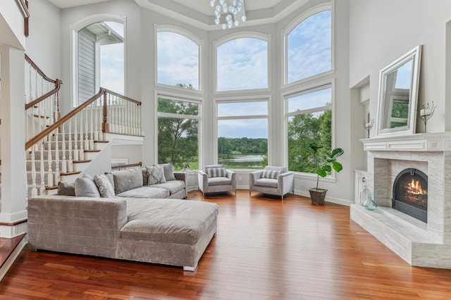 3287 Norcrest Ave N, Baytown Twp, MN 55082 - living area with hardwood / wood-style flooring, a towering ceiling, stairs, a tile fireplace, and a chandelier