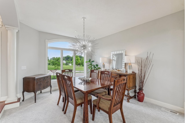 3287 Norcrest Ave N, Baytown Twp, MN 55082 - dining area featuring ornate columns, a chandelier, and light carpet