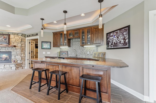 3287 Norcrest Ave N, Baytown Twp, MN 55082 - bar featuring a tray ceiling, decorative backsplash, a fireplace, decorative light fixtures, and recessed lighting